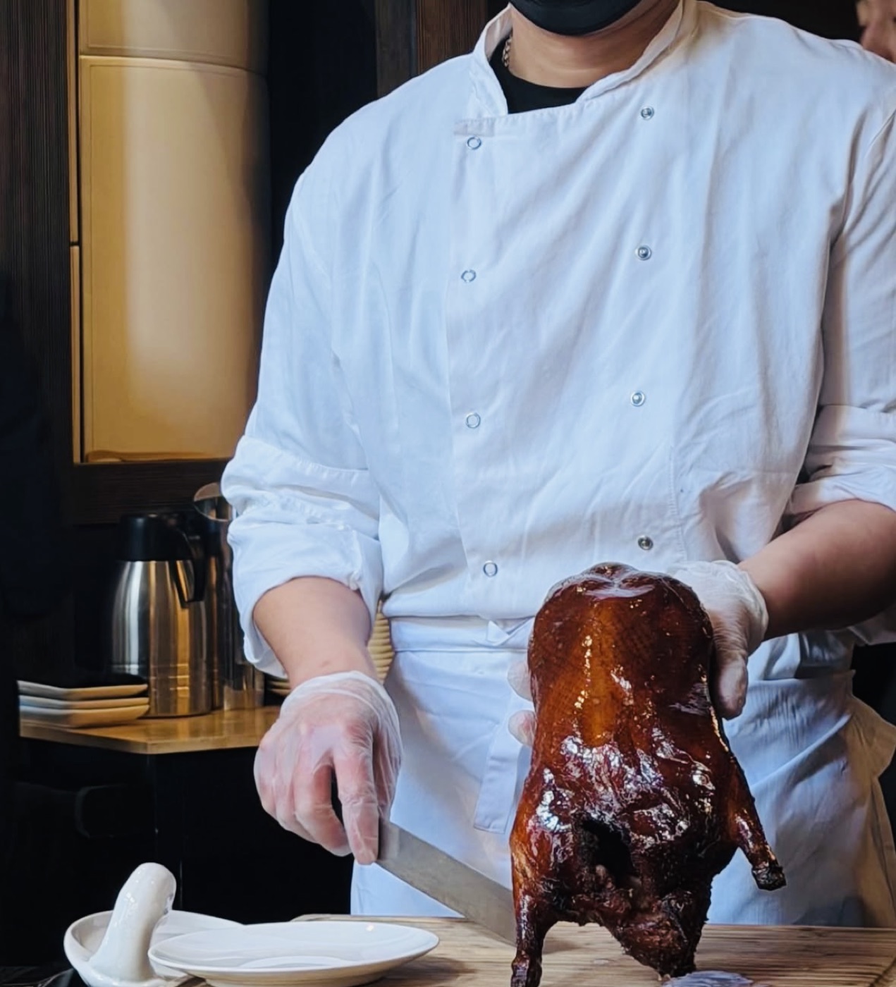 Chef presenting a refined dish for a bespoke personal occasion