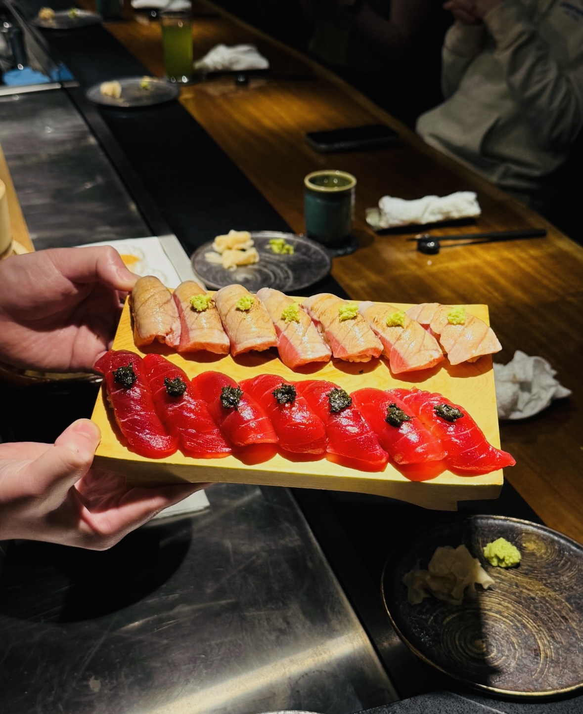Chef presenting a refined sushi course
