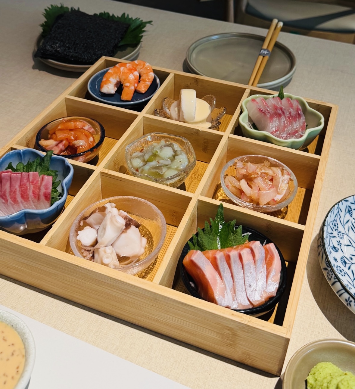 Japanese seafood selection arranged in a wooden box