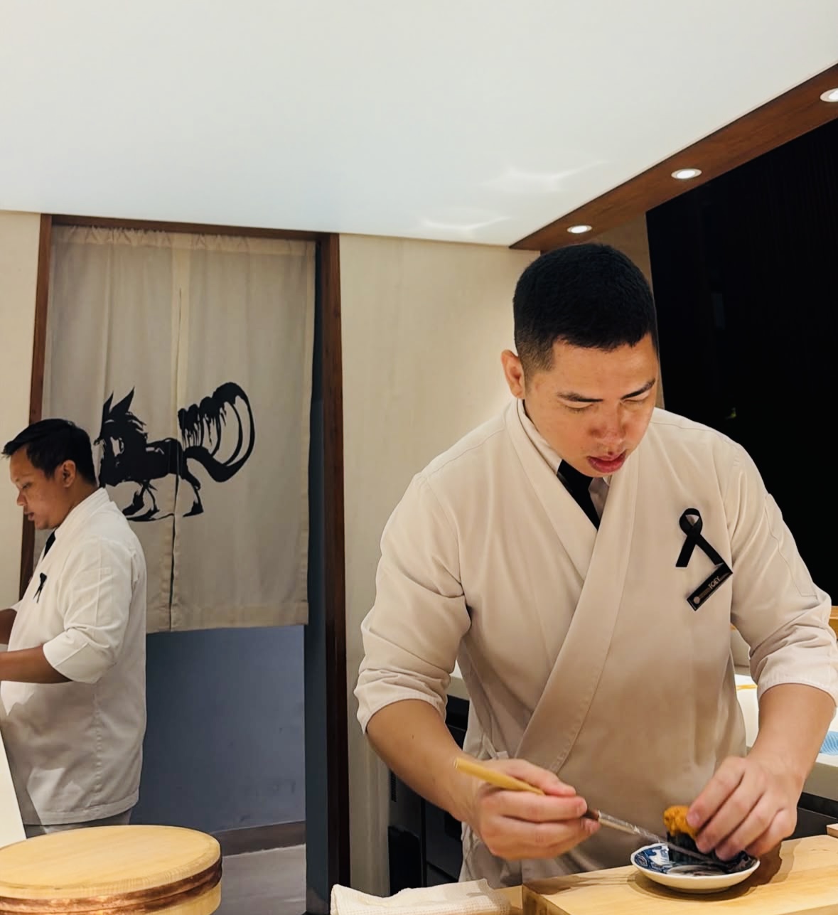 Chef plating a refined dish